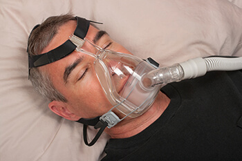 Image of a man in a cpap mask sleeping